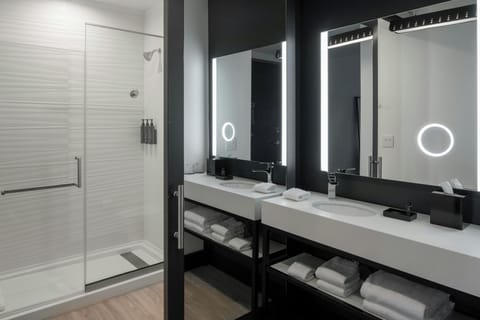 Shower, designer toiletries, hair dryer, towels