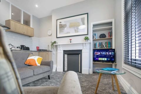 An open-plan living room with indoor fireplace, dining area and kitchen, benefit from a SMART TV with Netflix and plenty of space to sit down and relax. 