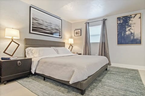 Queen bed — steps from the kitchen and living area.