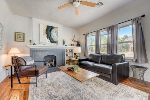 Cozy living room with warm natural light, modern décor, and a stylish fireplace centerpiece.