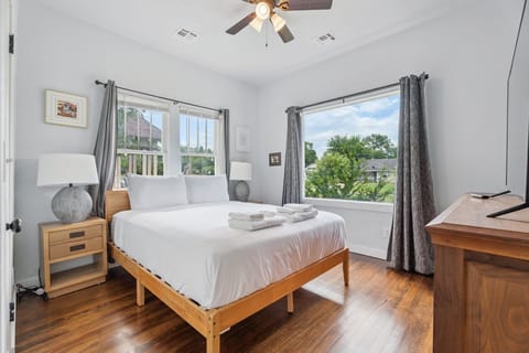Bedroom — queen bed with blackout curtains.