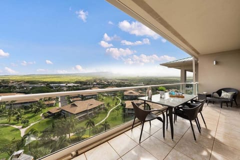 Spacious balcony with seating and panoramic views of greenery and mountains