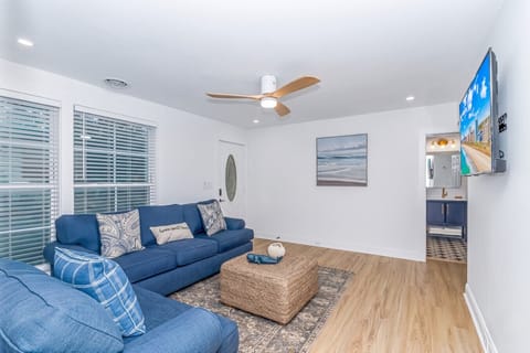Relax in the open living area with cozy seating & large TV