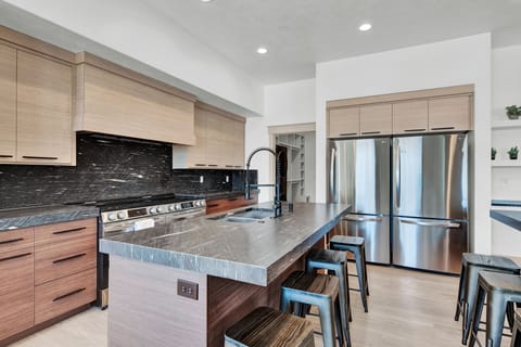 Kitchen with cooking island and iland for eating with 8 stools

