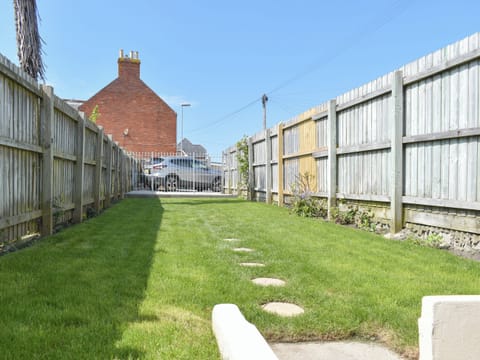 Garden with parking area at far end | Newstead Cottage, Weymouth