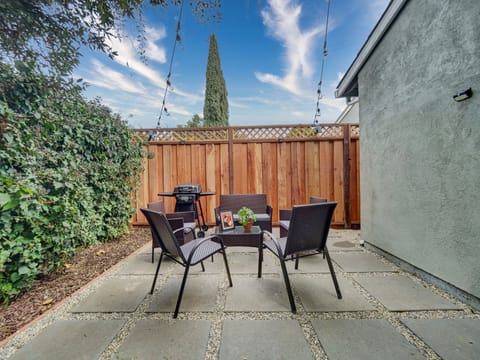 Newly renovated/ welcoming shared backyard featuring a willow tree, brand-new furniture, and a BBQ