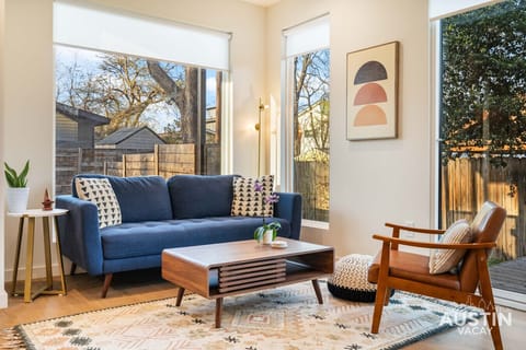 Relax into the plush sofa and enjoy a slow afternoon in this sun-drenched space.