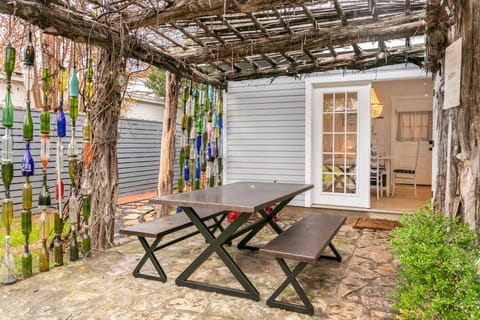 Enjoy a delightful al fresco dining experience under the pergola in the backyard.