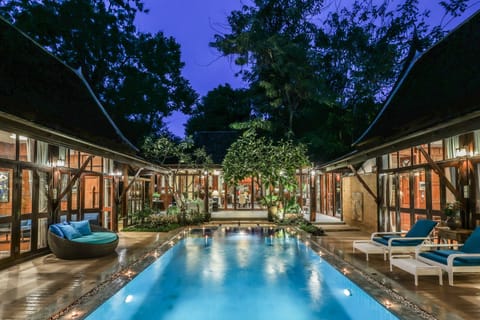 Evening view of our serene pool surrounded by Lanna-style architecture.