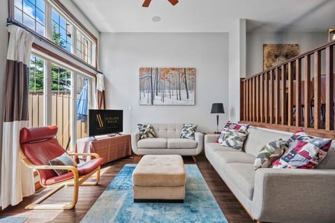 Living room on the main floor with a gas-lit fireplace and access to one of the two private balconies.