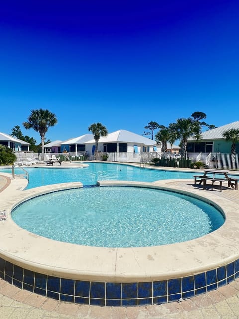 Blue skies, pool time! 
Cottage is white with blue shutters!