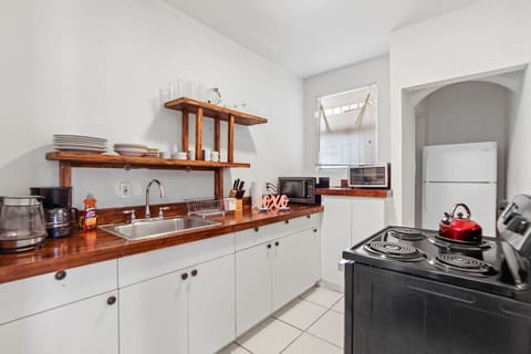 Spacious kitchen equipped with pots, pans, silverware, and more.