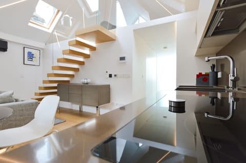 1 Bedroom Deluxe Penthouse | Living area | 32-inch flat-screen TV with cable channels, heated floors