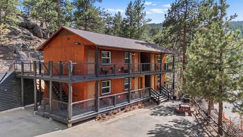 The hotel building has six units, a grill and a picnic table. 