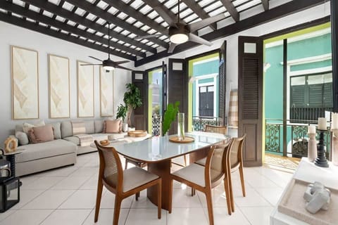 The living and dining spaces encompassed by the spectacular triple-door balcony that oversees San Se' street.