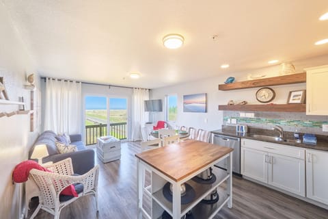 Living room with conjoined dining room and kitchen.