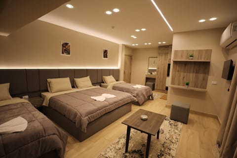 Deluxe Quadruple Room | Minibar, in-room safe, desk, laptop workspace