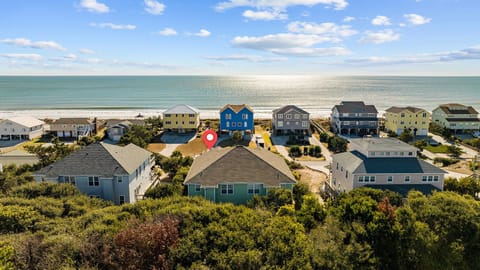Coastal community featuring beachfront vacation homes with direct ocean access and pristine sandy shoreline.