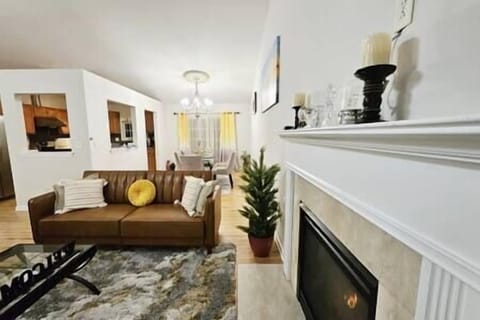 Spaciously Stylish Living Area with Fireplace and Dining View