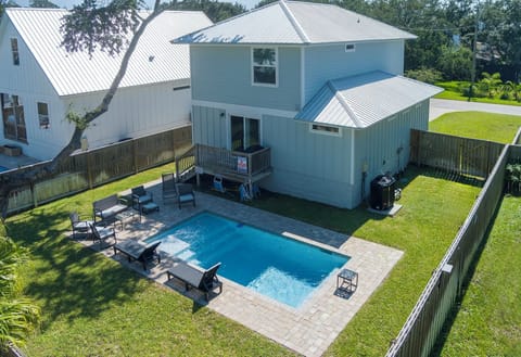 Enjoy your own fenced-in oasis with a sparkling private pool, sunny lounge seating, and plenty of space to relax—perfect for laid-back afternoons and unforgettable vacation vibes.