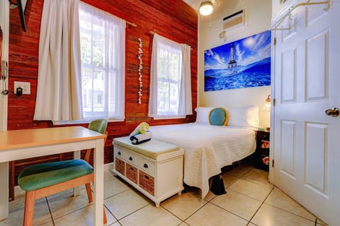 The queen bed exudes comfort and luxury, beckoning with its plush pillows, soft linens, and inviting ambiance, promising a restful retreat.