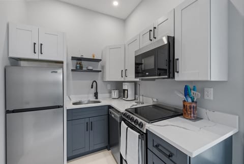 Kitchen with coffee maker, toaster, and all standard appliances, including dishwasher.