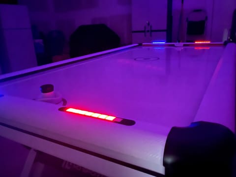Enjoy a game on the LED air hockey table.