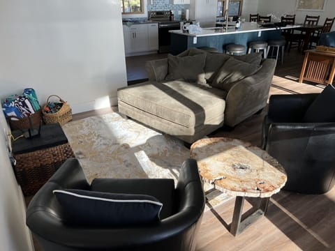 Cozy sitting area with large wall TV in living area.