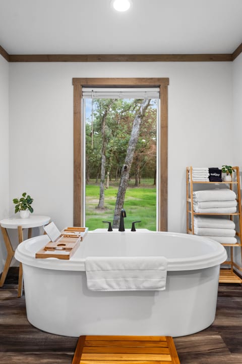 Soak in the tub while you soak in the forest view.