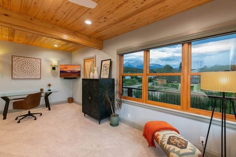 Master bedroom with cozy seating and scenic views. 