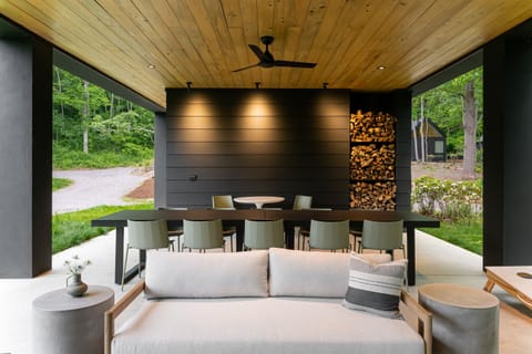 Our welcoming covered pavilion features a banquet table, cafe tables, and lounge seating around the fireplace
