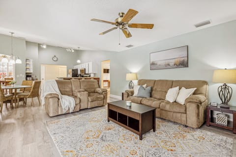 Relax and entertain in this generous living space, featuring a comfortable seating arrangement.