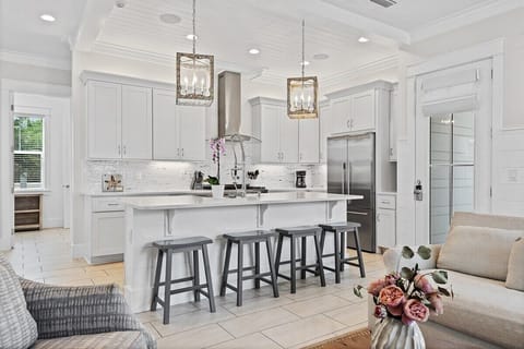 Additional bar seating means a place for everybody. Quartz countertops mean easy cleanup!