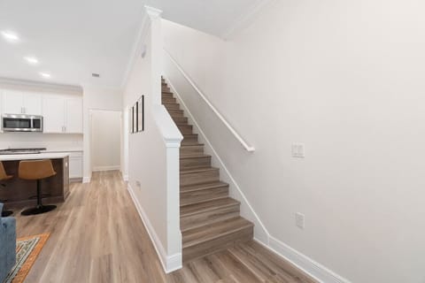 Stairs lead to the two second floor bedrooms. There is one bedroom with a full size bathroom on the first floor behind the kitchen. The other two bedrooms, each with full bathrooms, are located on the second floor.