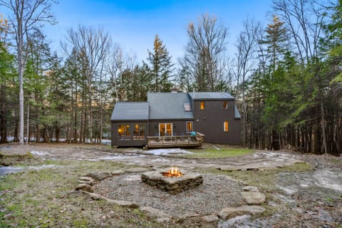 Fire pit and wooded backyard at dusk