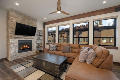 Sink into plush leather seating beside your crackling fireplace, where mountain views frame cozy evenings.