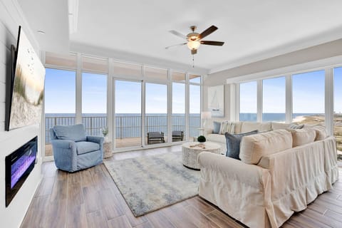 Recline in the blue chair by the fireplace and step onto the balcony for expansive gulf views