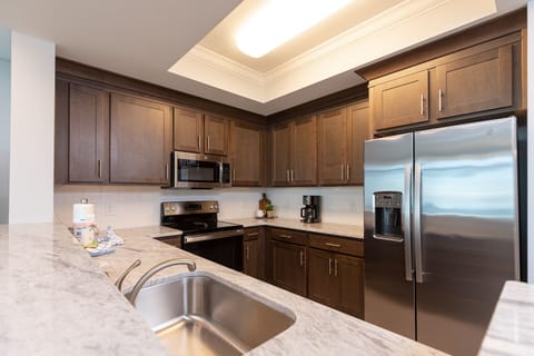 Prepare meals in this stylish kitchen with rich cabinetry and stainless appliances