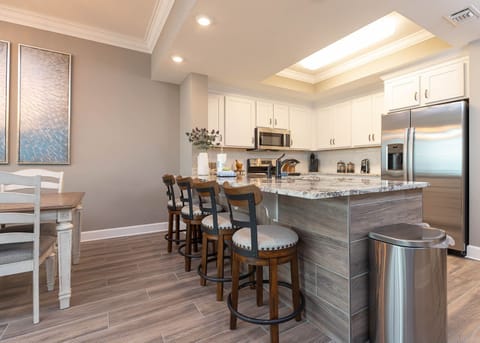 Sip your morning coffee at the breakfast bar and get ready for a beach day in this stylish space
