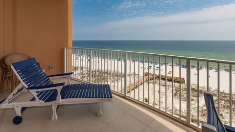 Recline on the balcony lounger and watch the gulf and colorful beach umbrellas dotting the shore