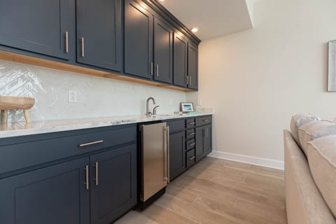 Make a chilled drink at the wet bar and pull a cold bottle from the undercounter fridge