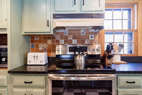 Kitchen includes electric stainless steel stove and oven