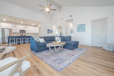 Bright open-concept living area with comfy seating and sleeper sofa — perfect for relaxing after a day on the water