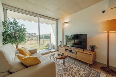 Deluxe Apartment, Garden View | Living area | TV