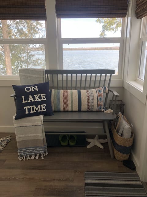 Beach blanket in basket next to bench.