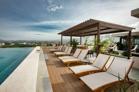 Enjoy a beautiful rooftop space with sweeping ocean and mountain views, perfect for relaxing, dining, or taking in the scenery.
