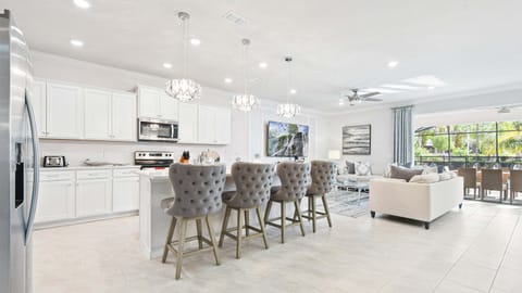 Sip on your favorite cocktails at our stylish kitchen bar, offering you a delightful way to unwind and relax.