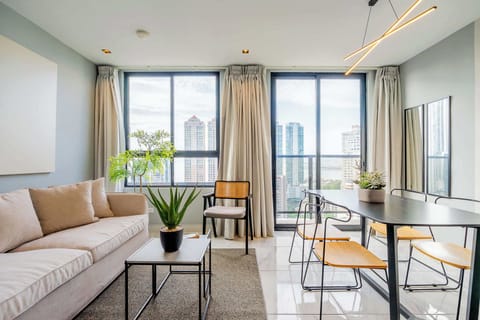 Bright living room with a cozy seating area and city views.