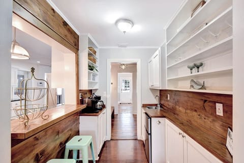 Rustic Coffee and Cocktail Bar – Beach Crew Cottage - This reclaimed wood bar is part coffee station, part cocktail corner—complete with a mini-fridge, sink, open shelving, and just the right touch of vacation flair. Whether it’s 8 a.m. espresso or 8 p.m. margaritas, this spot’s got you covered.