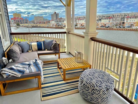 Master Bedroom Balcony-Enjoy breathtaking panoramic bay views and stunning sunsets right from your private, cozy balcony. Furnished with comfortable outdoor seating and stylish decor, this space is an ideal retreat for relaxation.
